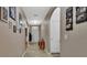 Welcoming hallway with archway, tile flooring, and decorated walls with photos and artwork at 859 Oak Hollow Loop, Deland, FL 32724