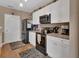 Well-equipped kitchen with white cabinetry, sleek appliances, and ample counter space for cooking enjoyment at 859 Oak Hollow Loop, Deland, FL 32724