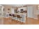 Modern kitchen with white cabinets, stainless steel appliances, breakfast bar, and wood flooring at 859 Oak Hollow Loop, Deland, FL 32724