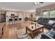 Open concept living space with modern kitchen island, dining area, and comfortable living room furniture at 859 Oak Hollow Loop, Deland, FL 32724