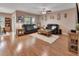 Spacious living room featuring hardwood floors, leather sofas, and an area rug that adds warmth to the space at 859 Oak Hollow Loop, Deland, FL 32724
