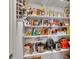 Organized pantry with shelving stocked with food items, and small appliances at 859 Oak Hollow Loop, Deland, FL 32724