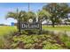 Welcome to DeLand sign surrounded by palm trees and lush landscaping at 859 Oak Hollow Loop, Deland, FL 32724