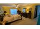 A traditionally styled bedroom with dark wood furniture and plenty of sunlight at 913 Lake Lindley N Dr, Deland, FL 32724