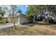 Lawn and the side of a house with attached garage and trimmed shrubs at 913 Lake Lindley N Dr, Deland, FL 32724