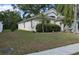 Well maintained front yard with trimmed shrubs and neutral paint at 913 Lake Lindley N Dr, Deland, FL 32724