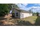 Back of house with neutral paint and well manicured yard at 913 Lake Lindley N Dr, Deland, FL 32724