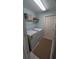 Laundry room with white washer and dryer and shelving at 913 Lake Lindley N Dr, Deland, FL 32724