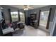 A well-lit office space with a desk, shelving, and multiple windows at 913 Lake Lindley N Dr, Deland, FL 32724