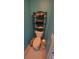 Toilet with shelving unit above for towels and accessories at 913 Lake Lindley N Dr, Deland, FL 32724