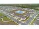 Aerial view of a neighborhood with a pond in the center at 9392 Revere Ave, Leesburg, FL 34788