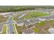 Aerial view featuring a pond, playground, and green spaces within the community at 9392 Revere Ave, Leesburg, FL 34788