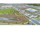 Aerial view showing community amenities, including ponds, playground, and green spaces at 9392 Revere Ave, Leesburg, FL 34788