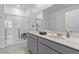 Bathroom featuring double vanity, glass shower, and modern fixtures at 9392 Revere Ave, Leesburg, FL 34788