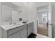 Spacious bathroom with double vanity, gray cabinets, quartz counters, and tile flooring at 9392 Revere Ave, Leesburg, FL 34788