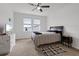 Bright bedroom offers natural light, a stylish bedspread, and a modern dresser at 9392 Revere Ave, Leesburg, FL 34788