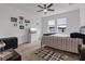 Spacious bedroom boasts natural light, a striped bedspread, and modern decor at 9392 Revere Ave, Leesburg, FL 34788