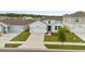 Well-maintained home with a two-car garage and a lush front lawn at 9392 Revere Ave, Leesburg, FL 34788