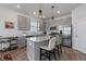 Clean kitchen featuring stainless steel appliances, a kitchen island with counter seating, and white countertops at 9392 Revere Ave, Leesburg, FL 34788