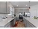 Bright kitchen offering stainless steel appliances, white countertops, and ample gray cabinets for storage at 9392 Revere Ave, Leesburg, FL 34788