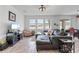 Bright living room area featuring a large, comfortable sofa with an entertainment area and natural light at 9392 Revere Ave, Leesburg, FL 34788