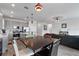 Open concept design connecting the modern kitchen, dining area, and living room, perfect for entertaining at 9392 Revere Ave, Leesburg, FL 34788