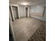 Bedroom with light gray walls, gray wood-look floors, and two closets at 130 Oak Tree Dr, Debary, FL 32713