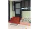 A home entrance with a decorative front door, black handrail, and a brick paver landing at 130 Oak Tree Dr, Debary, FL 32713