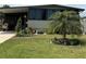 Charming home with well-manicured lawn, decorative landscaping, and a quaint palm tree at 130 Oak Tree Dr, Debary, FL 32713
