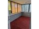 Bright sunroom featuring carpet floors, window coverings, and an air conditioner at 130 Oak Tree Dr, Debary, FL 32713