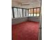 Bright sunroom with a ceiling fan, block walls, carpet floors, and natural light at 130 Oak Tree Dr, Debary, FL 32713