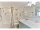 Well-lit bathroom with a tub, shower, and a stylish vanity with marble countertops at 100 Silver Beach Ave # 716, Daytona Beach, FL 32118
