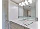 Bright bathroom featuring a large mirror, white countertops, and cabinets, offering ample storage and a clean design at 100 Silver Beach Ave # 716, Daytona Beach, FL 32118