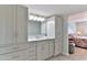 Elegant bathroom with white cabinetry, stylish fixtures, and a view of a bedroom, creating a serene retreat at 100 Silver Beach Ave # 716, Daytona Beach, FL 32118