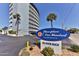 Exterior building sign for Riverplace One Hundred at 100 Silver Beach with palm trees at 100 Silver Beach Ave # 716, Daytona Beach, FL 32118