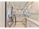Bright, galley kitchen featuring stainless steel appliances, white cabinets, and granite countertops at 100 Silver Beach Ave # 716, Daytona Beach, FL 32118