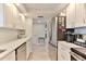Efficient kitchen layout with stainless steel appliances, white cabinets, and modern countertops at 100 Silver Beach Ave # 716, Daytona Beach, FL 32118