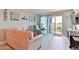 Comfortable living room featuring a cozy recliner and sofa, with sliding glass doors leading to a balcony at 100 Silver Beach Ave # 716, Daytona Beach, FL 32118