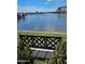 Picturesque water view featuring a bench, lush greenery, and a scenic bridge in the distance at 100 Silver Beach Ave # 716, Daytona Beach, FL 32118