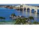 Beautiful waterfront view with a bridge, boat dock, and palm trees enhancing the scenic location at 100 Silver Beach Ave # 716, Daytona Beach, FL 32118