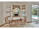 Cozy dining area featuring a glass table, and direct access to the screened pool area at 1033 Pearl Tree Rd, Deltona, FL 32725