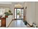 Bright foyer with white tile flooring, a glass storm door, and views of the front yard at 1033 Pearl Tree Rd, Deltona, FL 32725