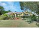 Charming single-story home with a well-manicured lawn and mature landscaping on a sunny day at 1033 Pearl Tree Rd, Deltona, FL 32725