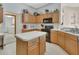 Bright kitchen with wood cabinets, modern appliances, and ample counter space at 1033 Pearl Tree Rd, Deltona, FL 32725