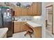 Cozy kitchen featuring light wood cabinets, white countertops, and a black refrigerator with unique decor at 1033 Pearl Tree Rd, Deltona, FL 32725