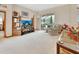 Comfortable living room with plush carpeting, a large sliding glass door to the lanai, and neutral tones at 1033 Pearl Tree Rd, Deltona, FL 32725