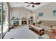 Bright living room featuring a fireplace, vaulted ceiling, and seamless transition to the screened lanai at 1033 Pearl Tree Rd, Deltona, FL 32725