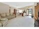 Open-concept space with a view of the dining area and a glimpse of the front yard through glass doors at 1033 Pearl Tree Rd, Deltona, FL 32725