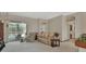 Bright living room with a view of the pool, a tan sofa set, and a neutral color palette at 1033 Pearl Tree Rd, Deltona, FL 32725