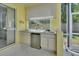 Covered outdoor kitchen with stainless appliances, sink, and ample counter space for entertaining at 1033 Pearl Tree Rd, Deltona, FL 32725